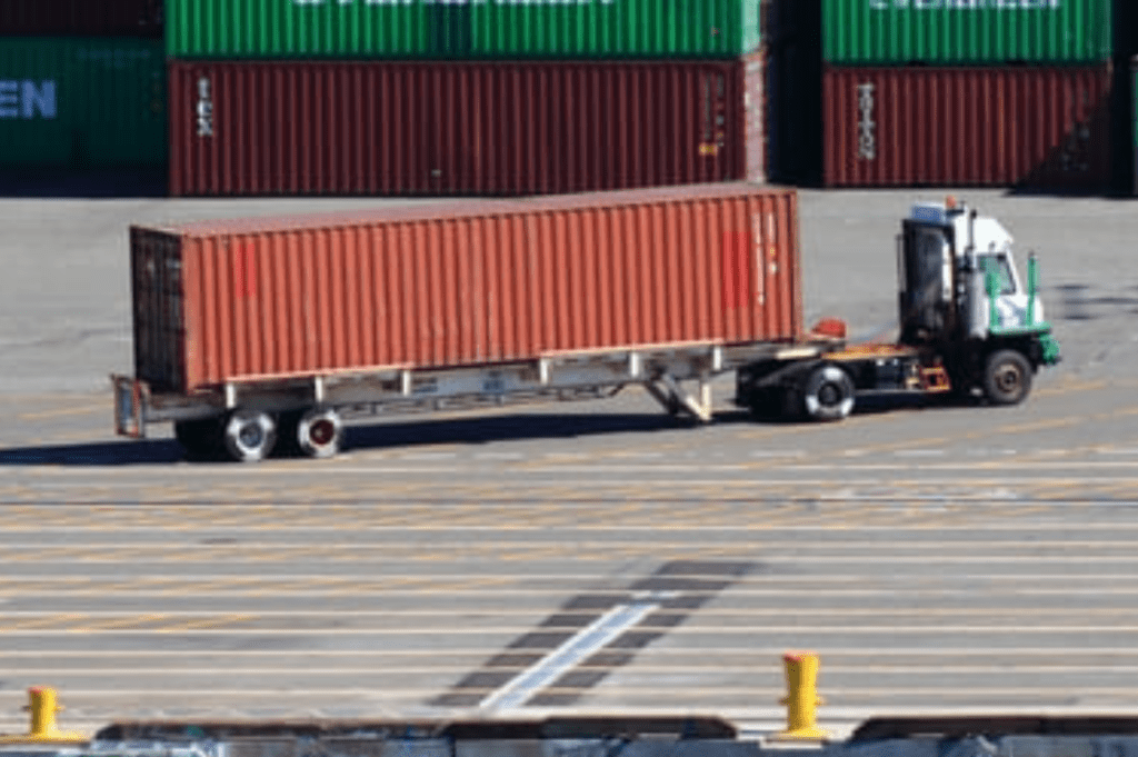 Intermodal drayage truck transporting shipping container between rail yard and warehouse