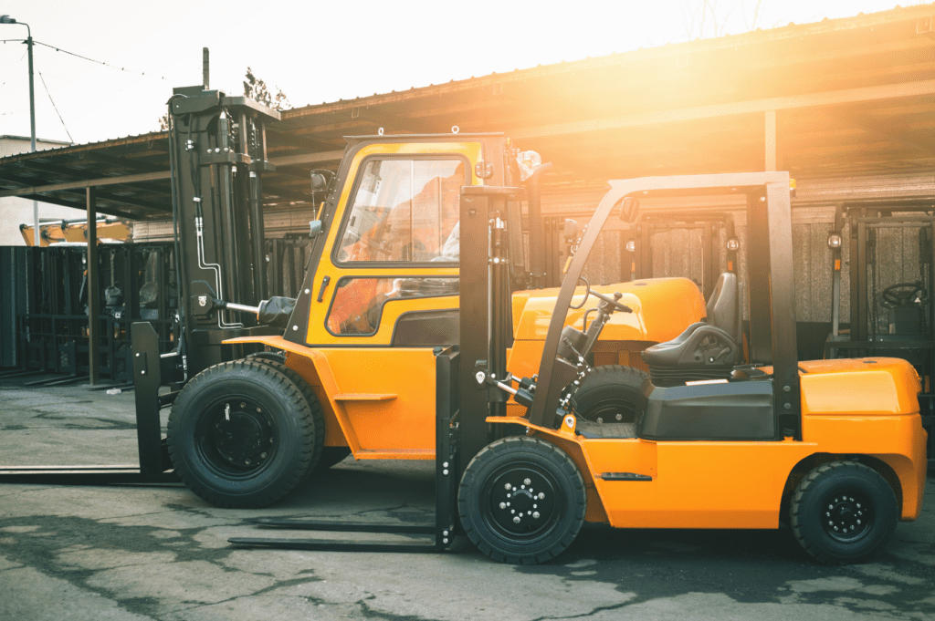 Large capacity forklift operating inside an OLIMP warehouse, lifting heavy palletized goods for storage or distribution.