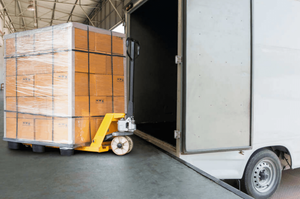 Palletized freight being cross-docked in Miami warehouse for same-day delivery.