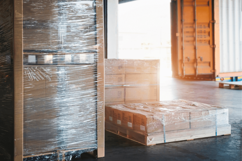 Palletized cargo staged for container drayage and transloading in Miami, FL warehouse.