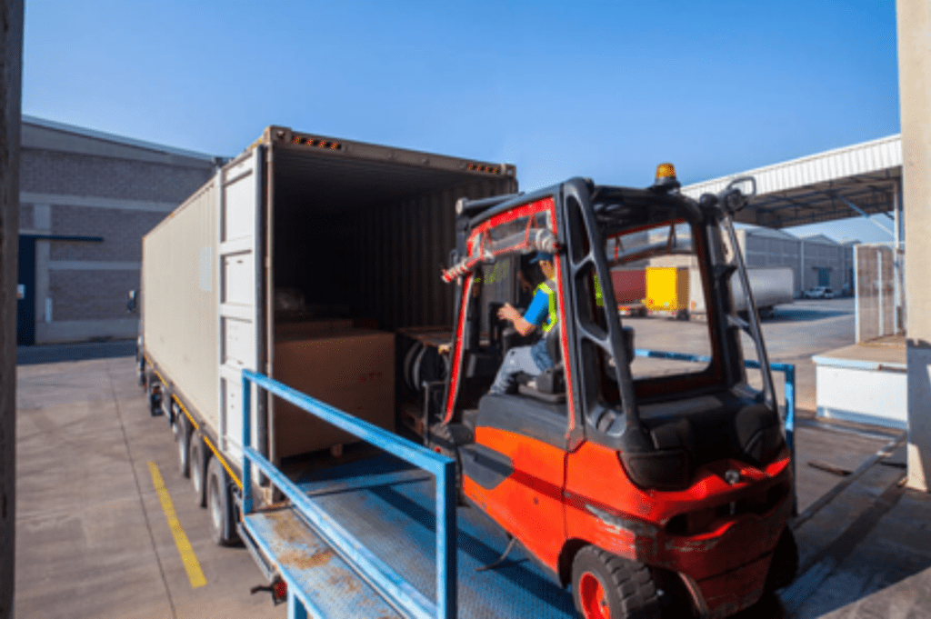 Forklift unloading goods from trailer at a Memphis cross dock and warehouse.