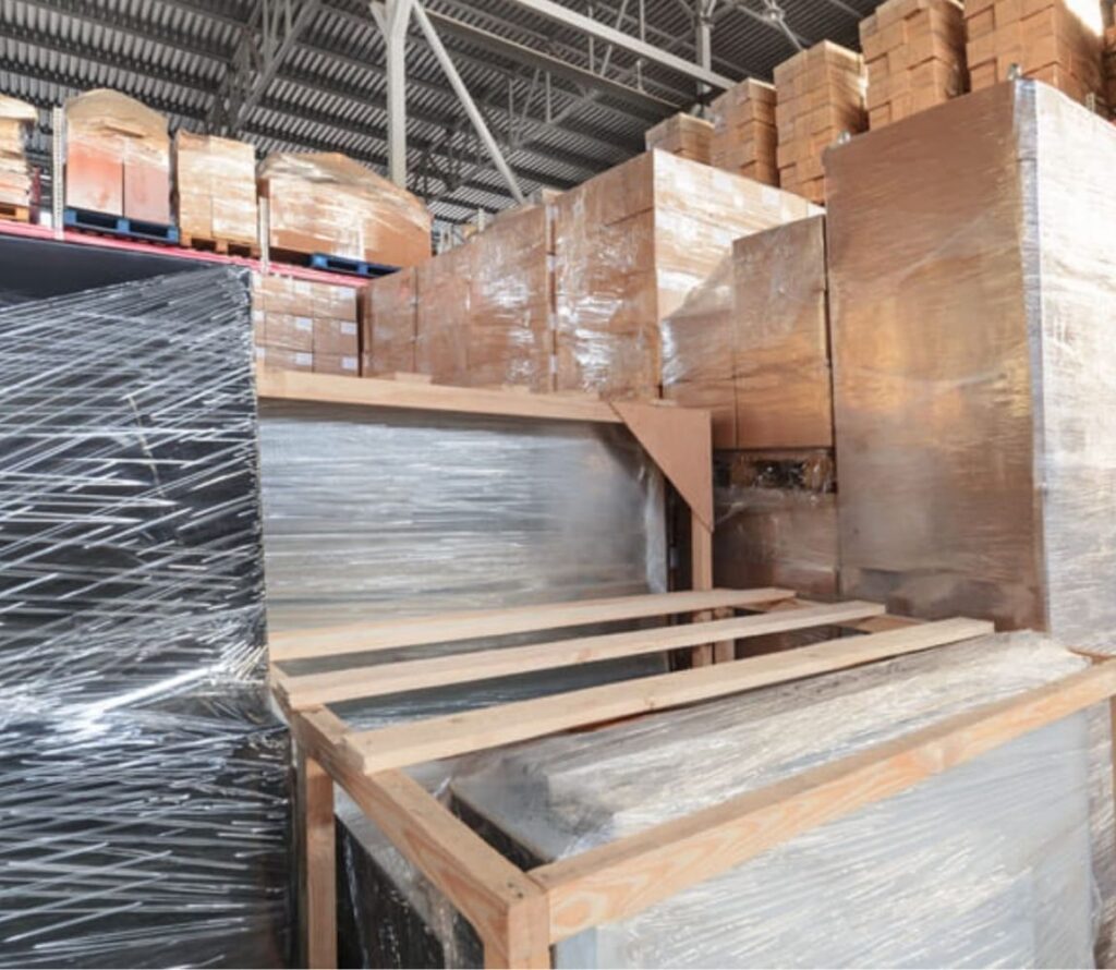 Forklift operator stabilizing shifted cargo for reloading in Youngstown, OH