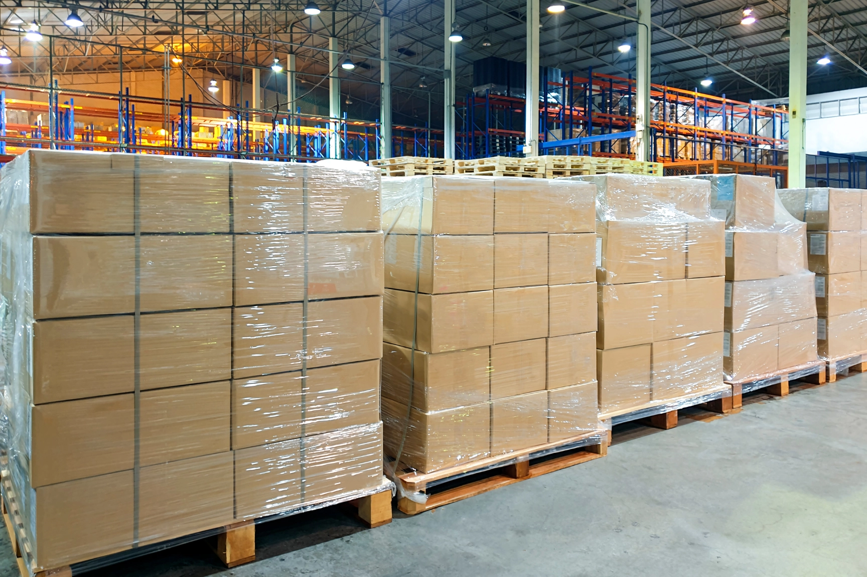 Organized ecommerce warehouse with rows of shelving and packages ready for shipment