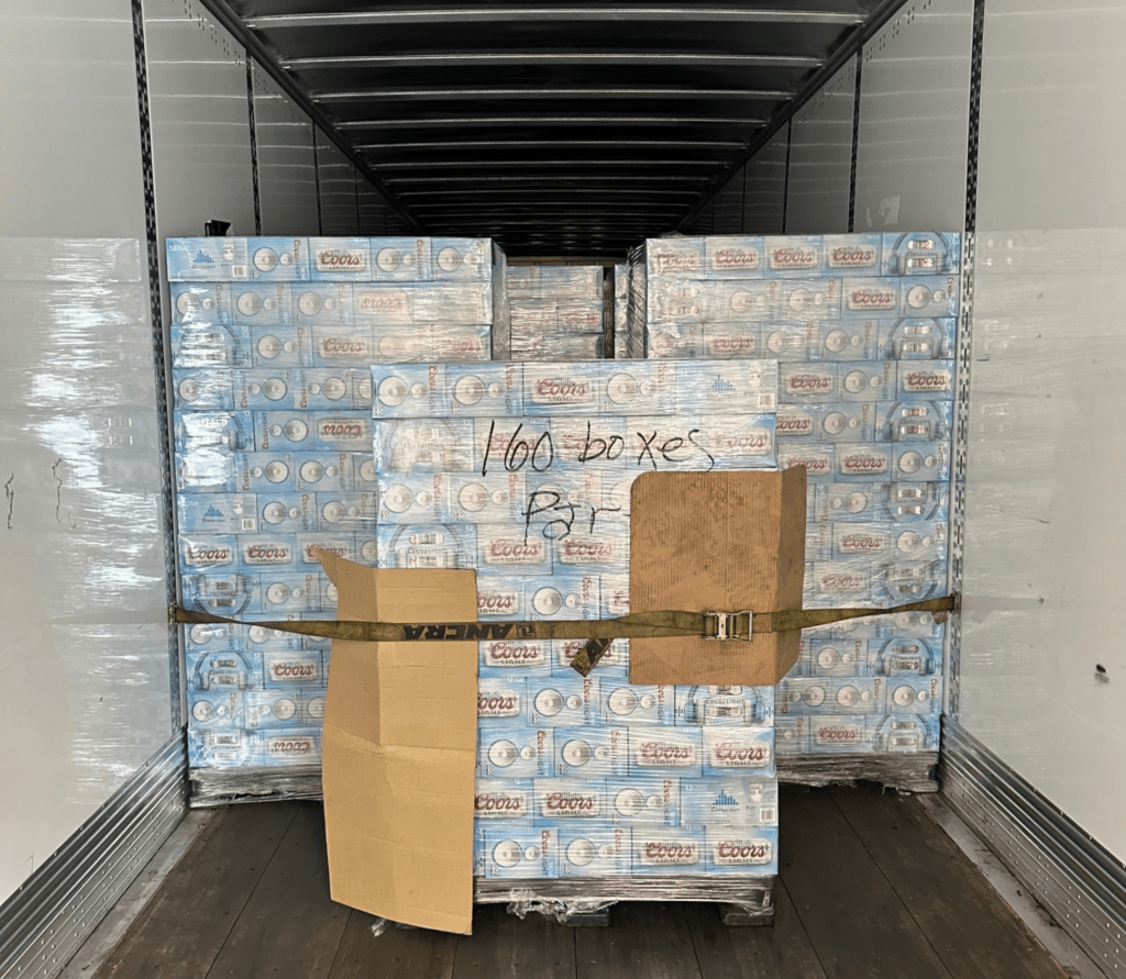 Logistics staff inspecting reworked pallets and preparing documentation for outbound shipment in long beach.