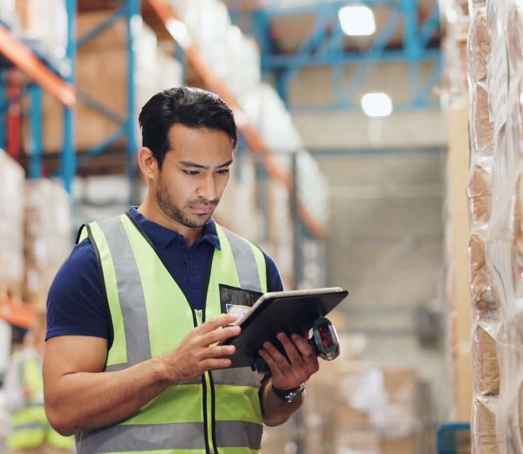 Warehouse staff managing inventory with WMS software