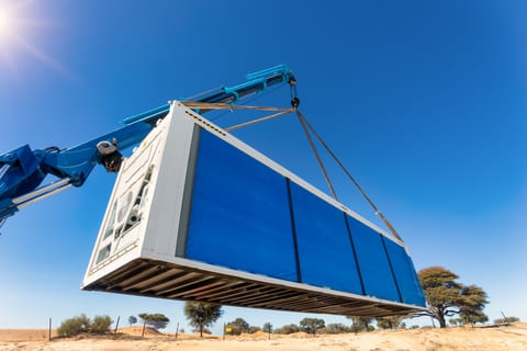A refrigerated “reefer” intermodal container being loaded by a crane. Reefers are essential for food, medical, and other perishable shipments, keeping cargo at precise temperatures.