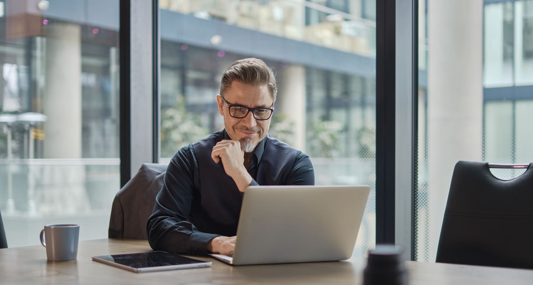 A logistics manager analyzing warehouse options on a laptop, comparing locations, pricing, and facility features to optimize supply chain operations.