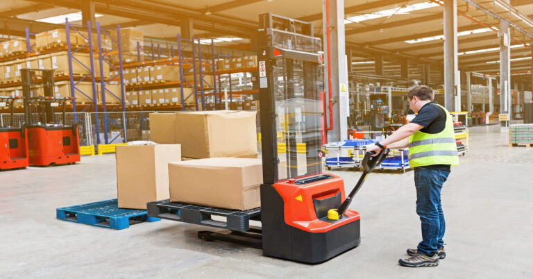 Warehouse with organized shelves and workers managing inventory.