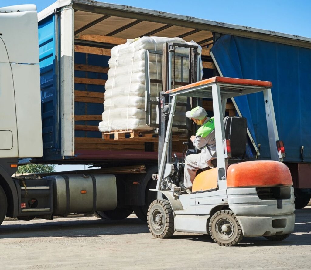 Cross-docking operations at OLIMP Warehousing Hopkinton showing fast freight transfer between inbound and outbound trucks.