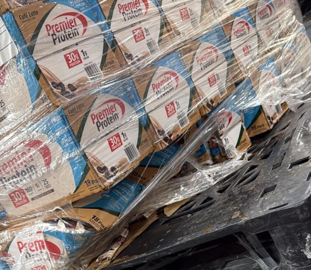 Workers reworking a damaged pallet for shipment