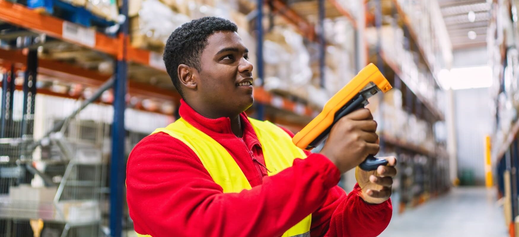 A Staples fulfillment center employee using a mobile scanner to manage inventory.