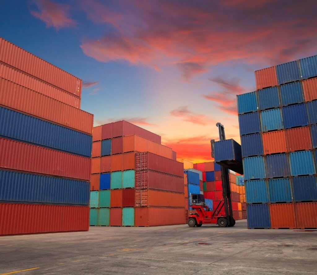 Warehouse facility near port with cargo containers being transloaded and drayed efficiently by OLIMP Warehousing.