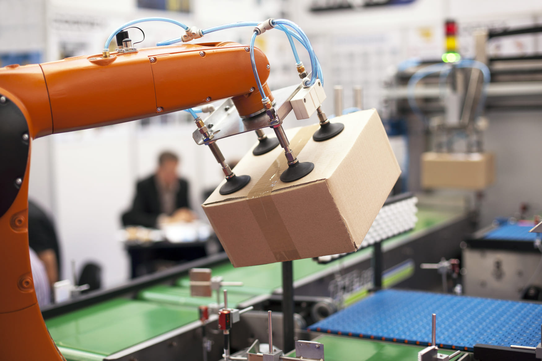Automated warehouse picking system with robots and workers using pick-to-light and barcode scanning tools to improve warehouse picking speed and accuracy.