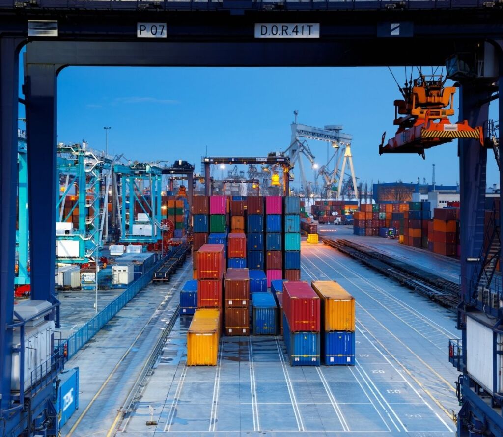 Expert transloaders moving goods between trucks and shipping containers with precision