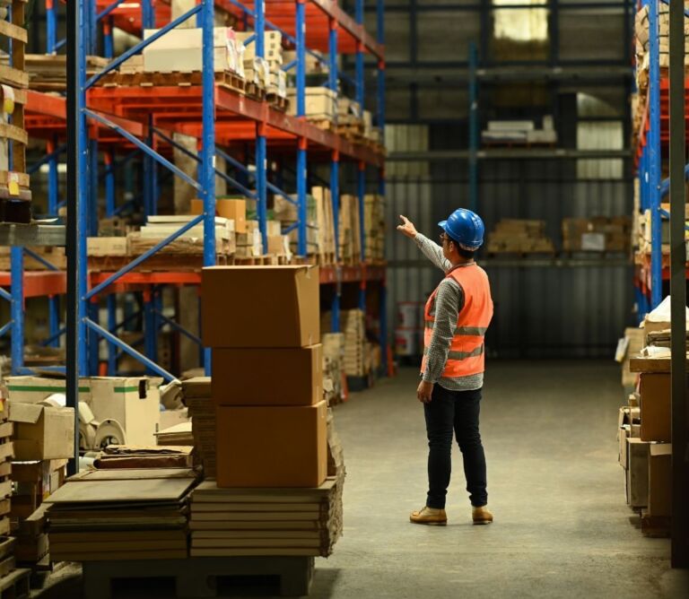 Retail employee stacking boxes in a flexible warehouse.