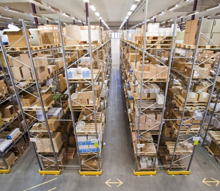 Warehouse worker scanning inventory for backorder management