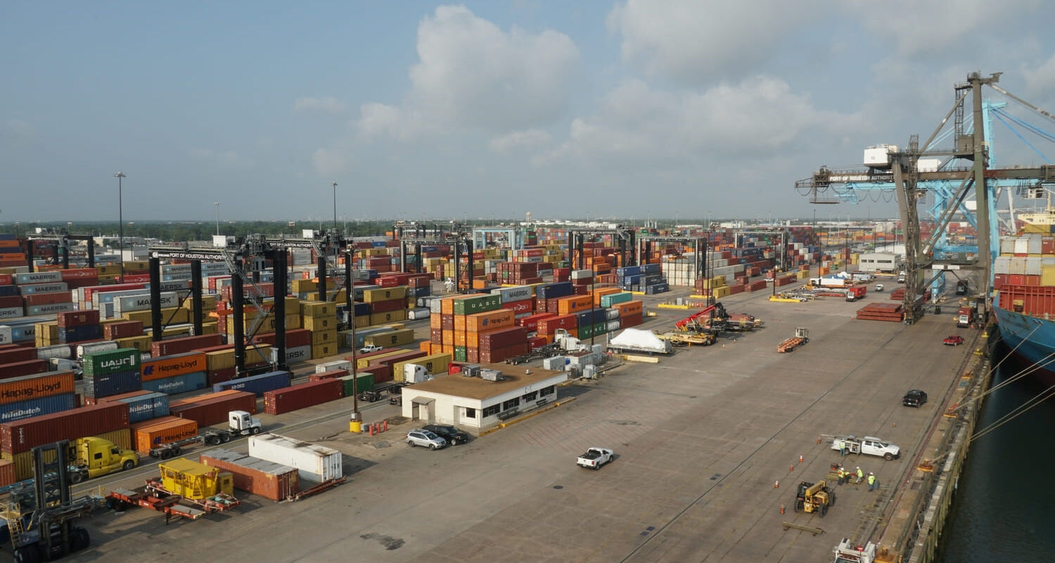 Warehouse space in Houston with freight trucks, pallets, and dock doors-representing 3PL services, cross-docking, and short-term storage solutions in a Houston logistics hub.