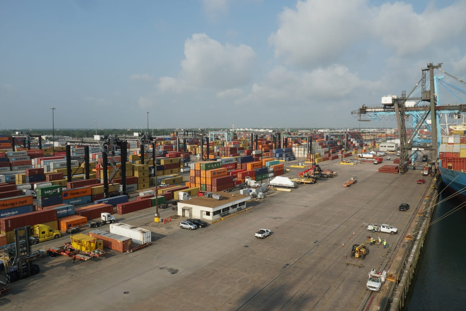 Warehouse space in Houston with freight trucks, pallets, and dock doors-representing 3PL services, cross-docking, and short-term storage solutions in a Houston logistics hub.