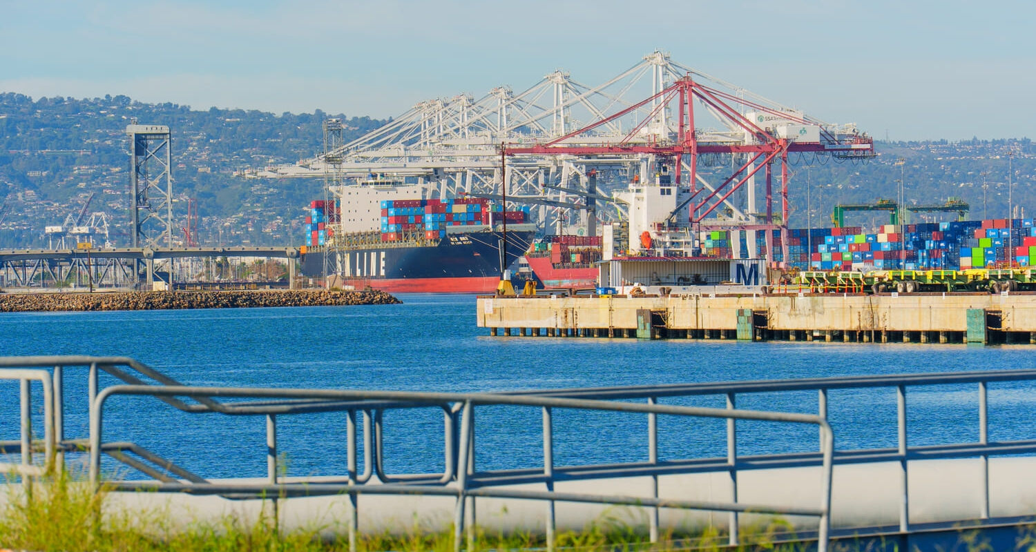 Container ship and cranes at the Port of Long Beach, showing California logistics and freight shipping operations.